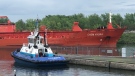 A tugboat sits nearby the Chem Hydra which got stuck on the natural bottom of the St. Lawrence Seaway early Friday morning (Scott Prouse, CTV News)
