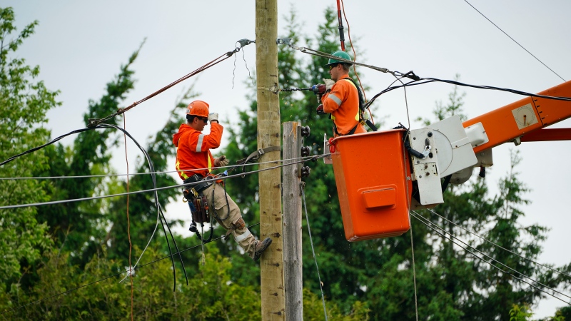 Hydro crews work to restore power in Clarence-Rockland, Ont., where a state of emergency is in place on Thursday, May 26, 2022. A major storm hit parts of Ontario and Quebec on Saturday, May 21, 2022, killing 11 people and leaving extensive damage to infrastructure, homes, and business. (Sean Kilpatrick/THE CANADIAN PRESS)