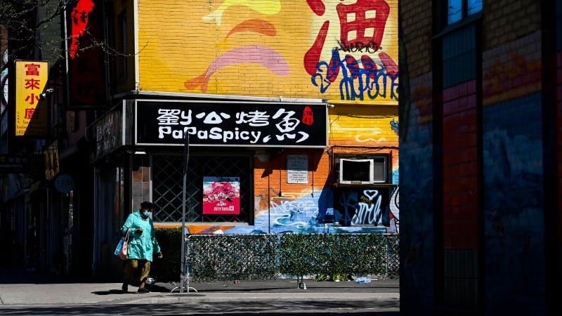 A person walks along Spadina Avenue in Chinatown in Toronto on Thursday, May 13, 2021. THE CANADIAN PRESS/Nathan Denette