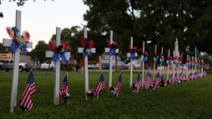 Twenty-one crosses and flags stand next to Main Street as a memorial for the victims killed earlier in the week during an elementary school shooting in Uvalde, Texas, Friday, May 27, 2022. (AP Photo/Dario Lopez-Mills)
