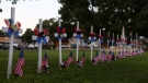 Twenty-one crosses and flags stand next to Main Street as a memorial for the victims killed during an elementary school shooting in Uvalde, Texas, Friday, May 27, 2022. (AP Photo/Dario Lopez-Mills)