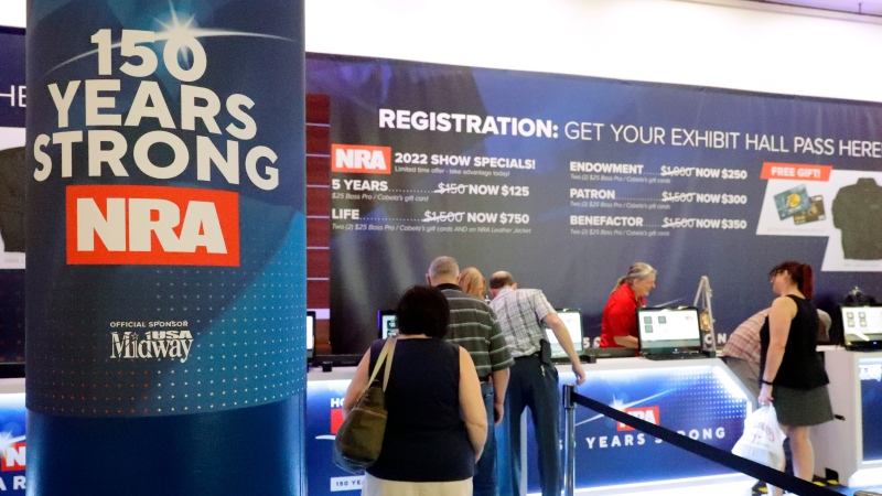 Convention attendees line up at the registration booth at the NRA Annual Meeting held at the George R. Brown Convention Centre Thursday, May 26, 2022, in Houston. (AP Photo/Michael Wyke)