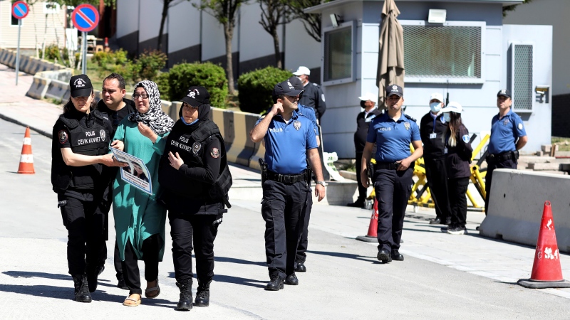 Police detain a Uyghur Turkish woman near the Chinese embassy, in Ankara, Turkey, Tuesday, May 24, 2022. A small group of Uyghurs staged a protest in Ankara on Tuesday, denouncing UN High Commissioner for Human Rights Michelle Batchelet's visit to China and demanding that the Turkish government take a stronger stance against human rights abuses in China's far-western Xinjiang region. (AP Photo/Burhan Ozbilici)