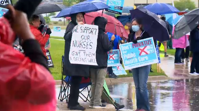 Demonstrators line the entrance to Bingeman's in Kitchener ahead of Doug Ford's campaign rally inside the venue on May 27, 2022. (CTV Kitchener)