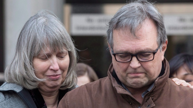 Clayton Babcock, right, stands next to his wife Linda as he reads a prepared statement outside court in Toronto on Saturday, December 16, 2017. THE CANADIAN PRESS/Chris Young