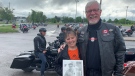 Ride for Dad organizer Marion Perry (left) and David Bailey wait for the launch of Ride For Dad’s 18th event in Kingston, Ont. Bailey holds a photo of her dad who she lost to prostate cancer in 1996. (Kimberley Johnson/CTV News Ottawa)