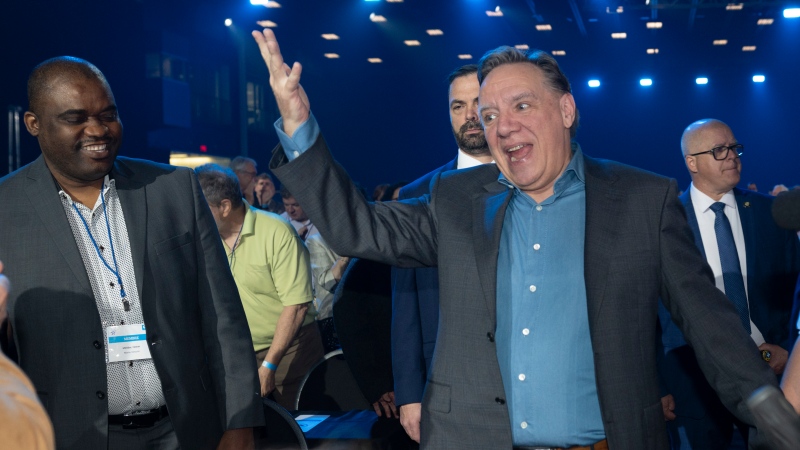 Quebec Premier Francois Legault waves to delegates as he enters a Coalition Avenir Quebec annual congress, in Drummondville, Que., Saturday, May 28, 2022. THE CANADIAN PRESS/Jacques Boissinot
