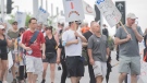 Croupiers take part in a march to the Casino in Montreal, Saturday, May 21, 2022, where they launched an unlimited general strike. THE CANADIAN PRESS/Graham Hughes