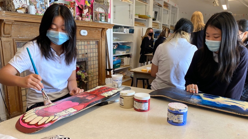 Vivian Chui designs a deck as part of the Skateboards for Hope project that provides boards for people around the world. (Kelly Greig/CTV News)