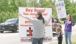 A small but passionate group gathered Saturday to protest the Ford government and autism therapy wait times outside PC MPP candidate Vic Fedeli's campaign office on McKeown Avenue. (Jaime McKee/CTV News)