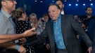 Quebec Premier Francois Legault shakes hand with delegates as he enters a Coalition Avenir Quebec annual congress, in Drummondville, Que., Saturday, May 28, 2022. THE CANADIAN PRESS/Jacques Boissinot