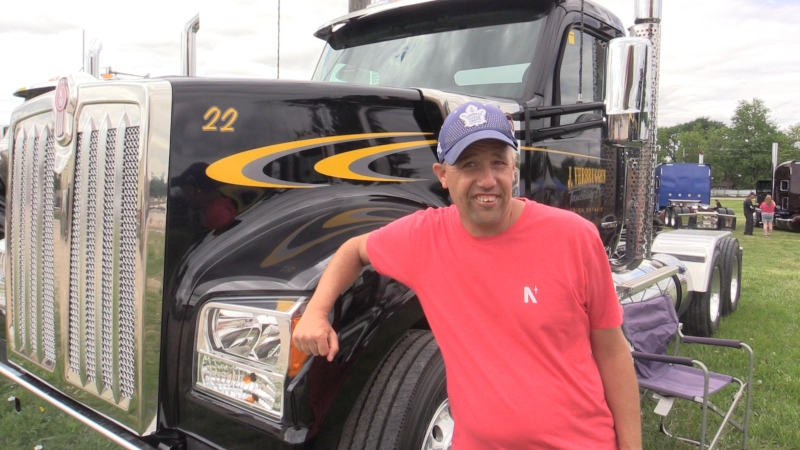Special Olympian and Woodstock Truck Show ambassador Chris Klein-Geltink shows off his favourite big truck at the Woodstock Truck Show on Saturday, May 28, 2022. (Brent Lale/CTV News London)