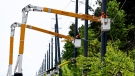 Utility workers use bucket lifts to repair lines along Hawthorne Road after Saturday’s major storm caused significant damage to the city’s power distribution network, in Ottawa, on Tuesday, May 24, 2022. THE CANADIAN PRESS/Justin Tang 