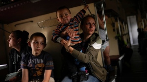 Yana Skakova and her son Yehor, who fled from Lysychansk with other people, sit in an evacuation train at a station in Pokrovsk, eastern Ukraine on May 28, 2022. Fighting has raged around Lysychansk and neighbouring Sievierodonetsk, the last major cities under Ukrainian control in Luhansk region. (AP Photo/Francisco Seco)