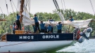 Crewmembers aboard HMCS Oriole secure a sail prior to stopping in Toronto during the ship’s 2018 Great Lakes deployment on June 22, 2018. (Royal Canadian Navy)