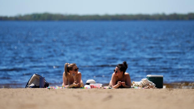People enjoy Westboro Beach as temperatures hit 31C in Ottawa on Friday, May 13, 2022. THE CANADIAN PRESS/Sean Kilpatrick