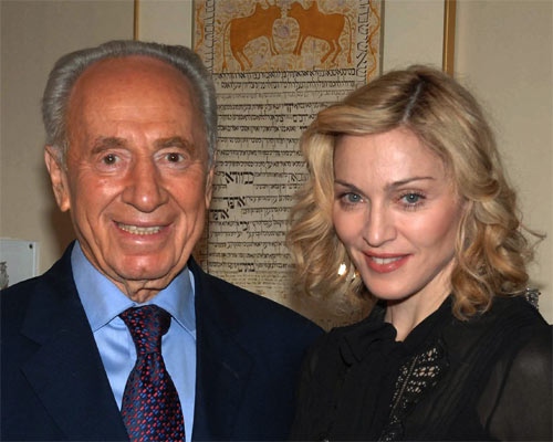 In this image released by Israel's Government Press Office, Israel President Shimon Peres, left, stands with pop star Madonna during a visit to the President's residence in Jerusalem, Saturday, Sept. 15, 2007. (AP Photo / Moshe Milner, GPO, HO)