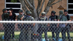 Law enforcement personnel stand outside Robb Elementary School following a shooting, May 24, 2022, in Uvalde, Texas. (AP Photo/Dario Lopez-Mills, File)