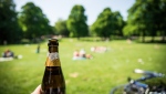 A person holds a beer in a public park. (Getty Images) 