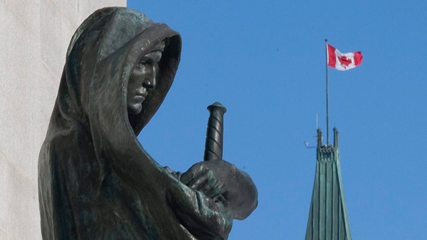 The statue of Justice outside the Supreme Court of Canada overlooks the Peace Tower on Parliament Hill in Ottawa, on Tuesday, Dec. 22, 2009. (Pawel Dwulit / THE CANADIAN PRESS)