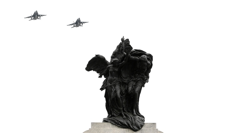 Royal Canadian Air Force CF-18 Hornets fly past the National War Memorial during a D-Day commemoration, in Ottawa, on Monday, June 6, 2022. (Justin Tang/THE CANADIAN PRESS)