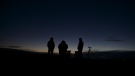 People watch the great conjunction of Jupiter and Saturn near Chancellorsville in Spotsylvania, Va., on Monday, Dec. 21, 2020. (Mike Morones/The Free Lance-Star via AP)