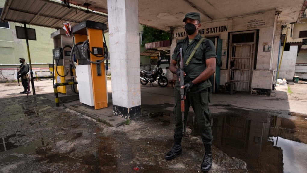 Soldiers secure a deserted fuel station in Colombo