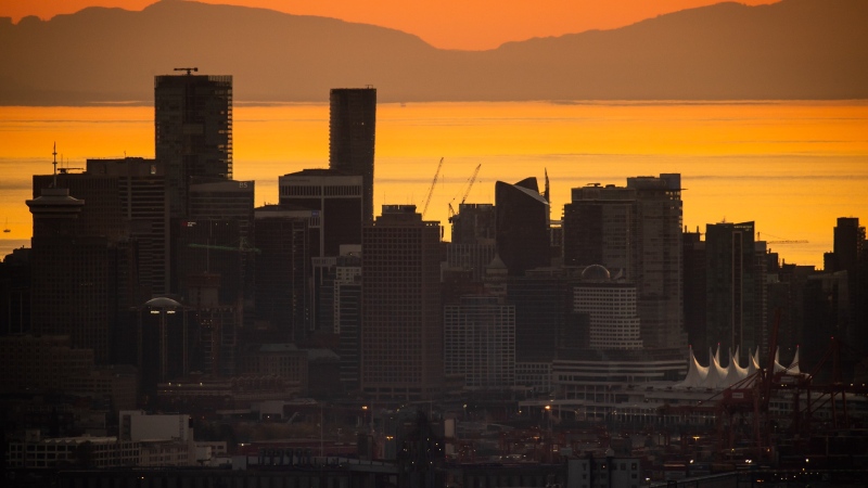 The downtown Vancouver skyline is seen at sunset with English Bay and Vancouver Island in the distance, as seen from Burnaby Mountain on Saturday, April 17, 2021. THE CANADIAN PRESS/Darryl Dyck