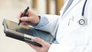 A doctor uses a tablet in a stock photo. (Getty Images)