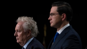 Conservative leadership candidate Jean Charest and Pierre Poilievre are seen during a debate at the Canada Strong and Free Network conference, Thursday, May 5, 2022 in Ottawa. THE CANADIAN PRESS/Adrian Wyld