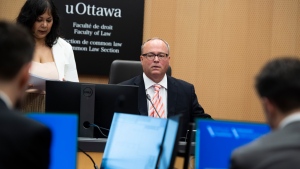 Justice William Hourigan, Commissioner of the Ottawa Light Rail Transit Commission, takes his seat before the start of the first day of proceedings at the inquiry into the troubled LRT system, in Ottawa, on Monday, June 13, 2022. (Justin Tang/THE CANADIAN PRESS)