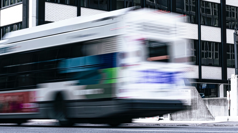 An OC Transpo bus travels down a street in Ottawa, Ont. in this undated photo.  (Photo by Parham Barati on Unsplash)