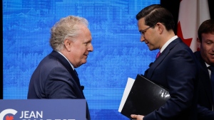 Jean Charest, left, and Pierre Poilievre shake hands following the Conservative Party of Canada English leadership debate in Edmonton, Alta., Wednesday, May 11, 2022.THE CANADIAN PRESS/Jeff McIntosh