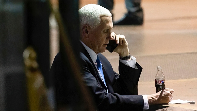 In this image from video released by the House Select Committee, Vice President Mike Pence talks on a phone from his secure evacuation location on Jan. 6 that is displayed as House select committee investigating the Jan. 6 attack on the U.S. Capitol holds a hearing Thursday, June 16, 2022, on Capitol Hill in Washington. (House Select Committee via AP)