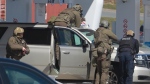 RCMP officers prepare to take Gabriel Wortman into custody at a gas station in Enfield, N.S. on Sunday April 19, 2020. (THE CANADIAN PRESS/Tim Krochak)