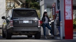 A woman fuels up an SUV at an Esso gas station, in Vancouver, on Tuesday, March 8, 2022. (THE CANADIAN PRESS/Darryl Dyck)