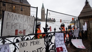 Crews secure fencing to shore up the existing gates along Wellington Street on Parliament Hill, on Thursday, Feb. 17, 2022. THE CANADIAN PRESS/Justin Tang