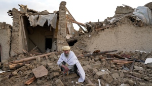 An Afghan sits by the rubble of his house earthquake in Gayan village, in Paktika province, Afghanistan, Thursday, June 23, 2022. A powerful earthquake struck a rugged, mountainous region of eastern Afghanistan early Wednesday, flattening stone and mud-brick homes in the country's deadliest quake in two decades, the state-run news agency reported. (AP Photo/Ebrahim Nooroozi)