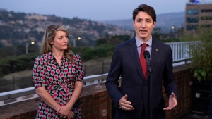 Prime Minister Justin Trudeau responds to questions flanked by Minister for Foreign Affairs Melanie July during a news conference in Kigali, Rwanda, Thursday, June 23, 2022. THE CANADIAN PRESS/Paul Chiasson