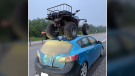 The MRC des Collines-de-l'Outaouais police say an officer stopped a Mazda 3 with an ATV strapped to the roof on Wednesday near Gatineau, Que. (Photo courtesy: MRC des Collines-de-l'Outaouais police)