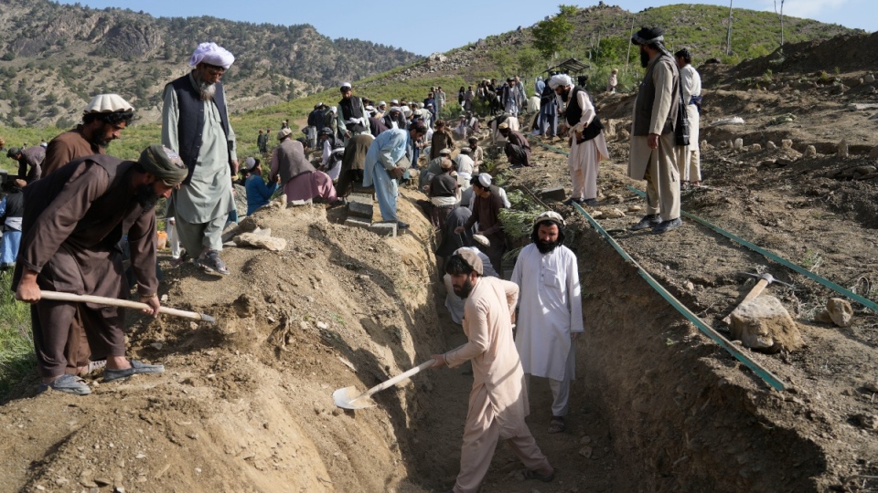 Digging a trench to bury quake victims