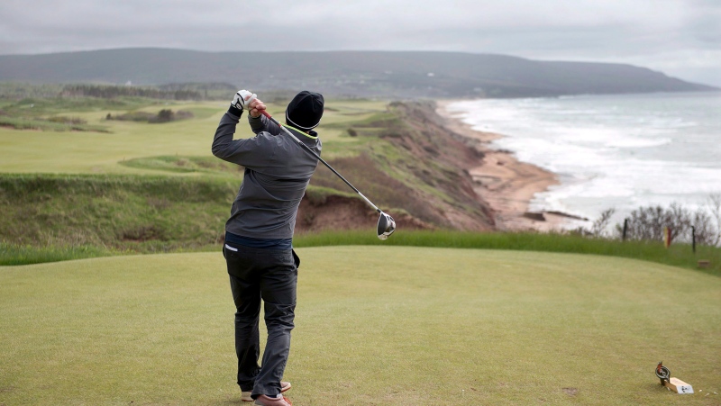 A golfer hits from the tee on the 528 yard, par 5, 18th hole at Cabot Cliffs on Wednesday, June 1, 2016. (THE CANADIAN PRESS/Andrew Vaughan) 