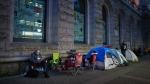 People camp out overnight in line outside a Service Canada passport office, in Vancouver, June 22, 2022. THE CANADIAN PRESS/Darryl Dyck