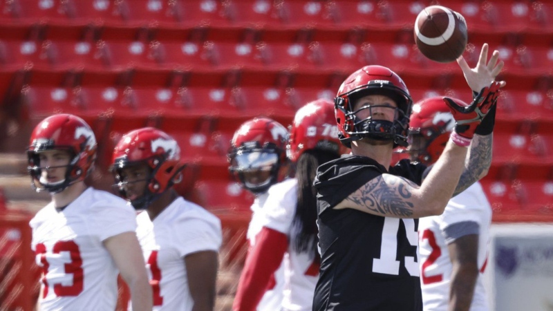 Calgary Stampeders quarterback Bo Levi Mitchell catches a ball during opening day of the CFL team's training camp in Calgary, Sunday, May 15, 2022. (THE CANADIAN PRESS/Jeff McIntosh)