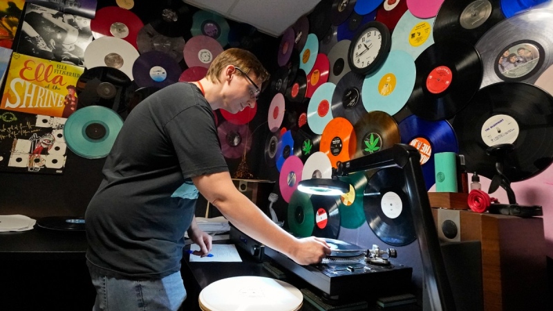 Tyler Bryant listens to finished record albums for flaws in a quality control room at the United Record Pressing facility, June 23, 2022, in Nashville, Tenn. (AP Photo/Mark Humphrey)