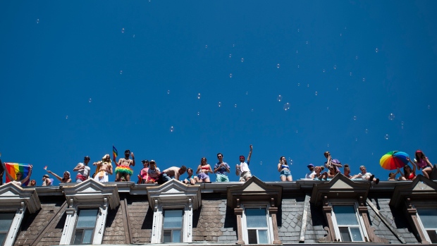Crowds take in the 2019 Pride Parade from a rooftop in Toronto, Sunday, June 23, 2019. THE CANADIAN PRESS/Andrew Lahodynskyj 