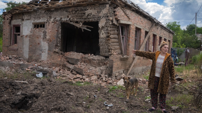 Local resident Tetyana points at her house heavily damaged by the Russian shelling in Bakhmut, Donetsk region, Ukraine, Friday, June 24, 2022.(AP Photo/Efrem Lukatsky)