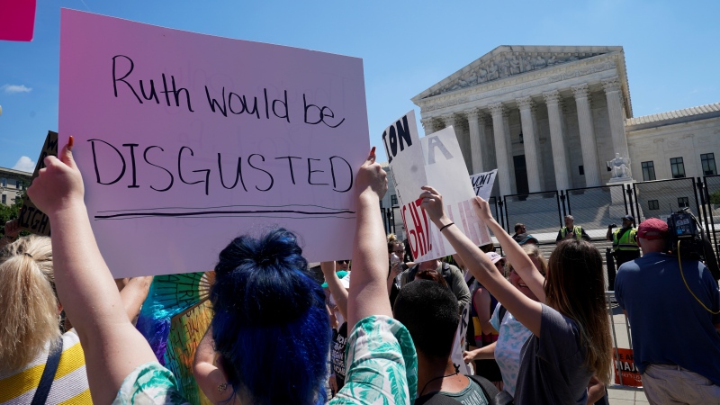 People protest about abortion outside the Supreme Court in Washington, Saturday, June 25, 2022. (AP Photo/Steve Helber)