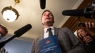 Quebec Justice Minister and French Language Minister Simon Jolin-Barrette holds a book containing the 1867 Canadian constitution and the Canadian Act during a news conference, Wednesday, June 8, 2022 at the legislature in Quebec City. THE CANADIAN PRESS/Jacques Boissinot