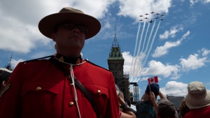 Royal Canadian Air Force Snowbirds and a CF-18 perform a flypast during the Canada Day noon show on Parliament Hill in Ottawa on Monday, July 1, 2019. (Justin Tang/THE CANADIAN PRESS)